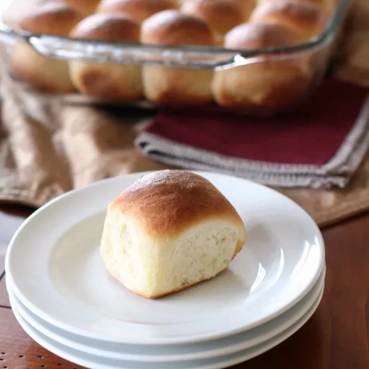 One bread roll on white plate