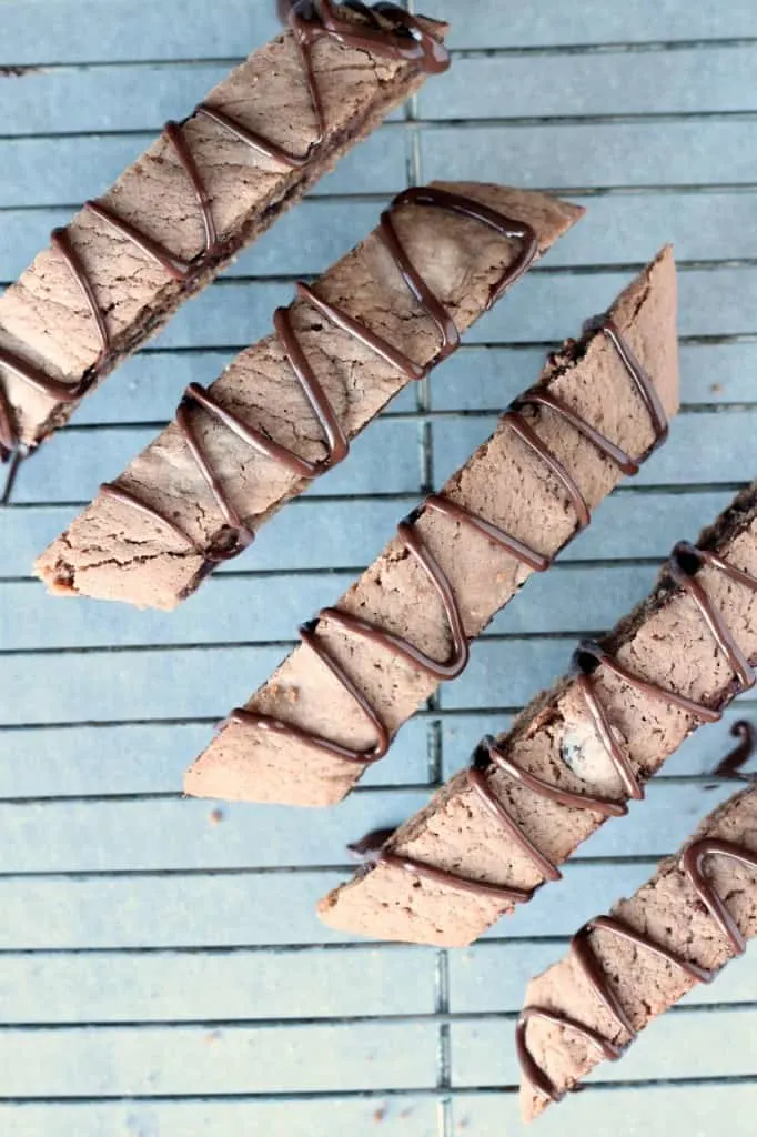 mocha biscotti drizzled with chocolate on wire rack