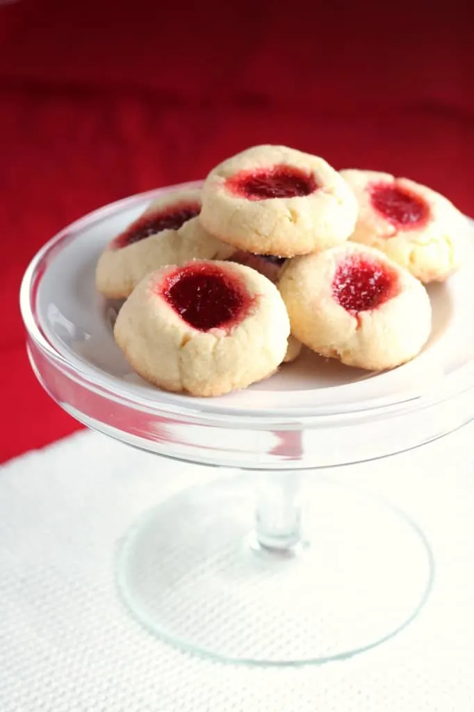 jam thumbprint cookies on glass cake stand