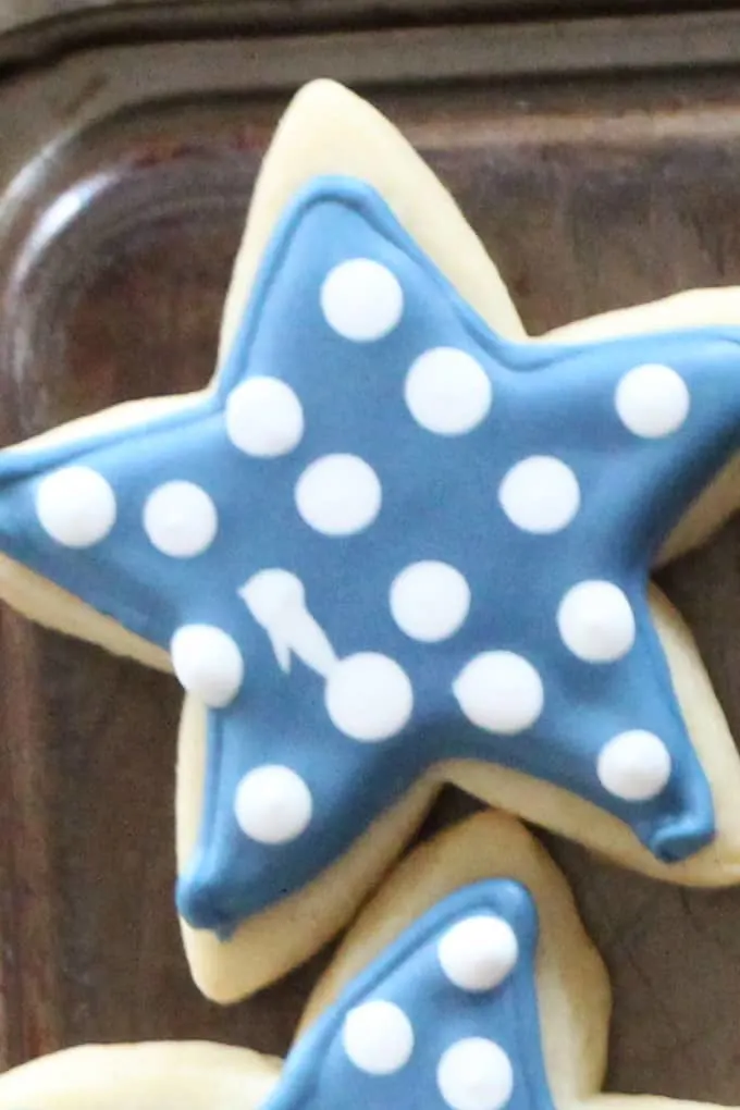 Star cookie cut out with blue and white royal icing