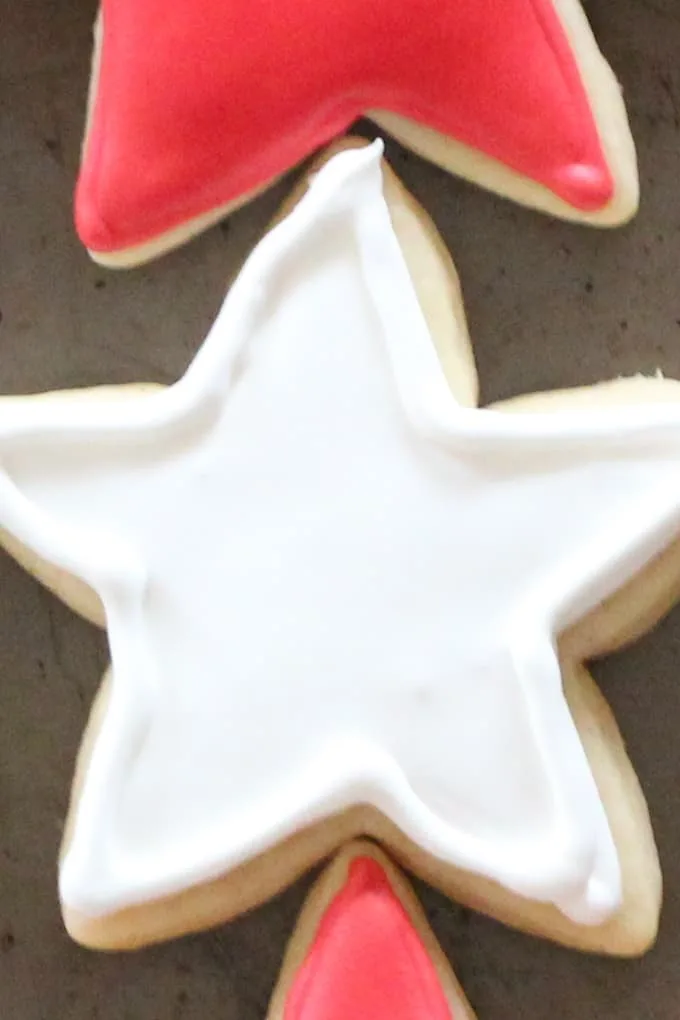Cut out cookie in the shape of a star decorated with white royal icing