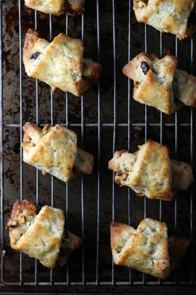 Pistachio Cranberry Rugelach on a baking rack on top of a baking tray