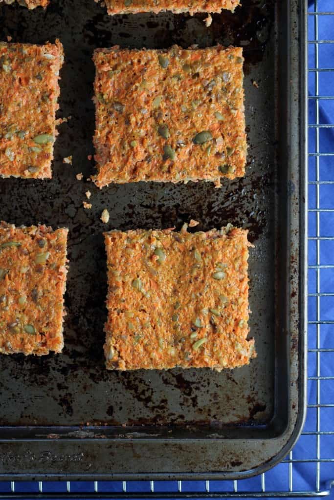 carrot flatbread on a baking pan with blue napkin