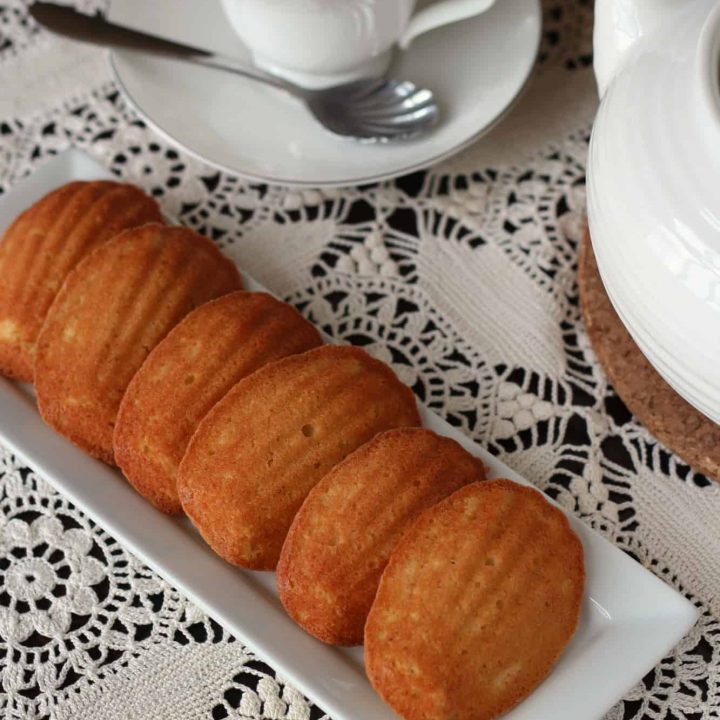 Tray of vanilla madelines on white lace tablecloth