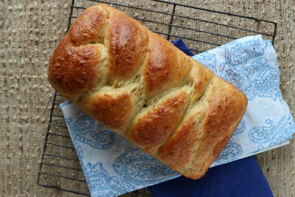 Italian Easter Bread on a wire cooling rack with blue printed napkin