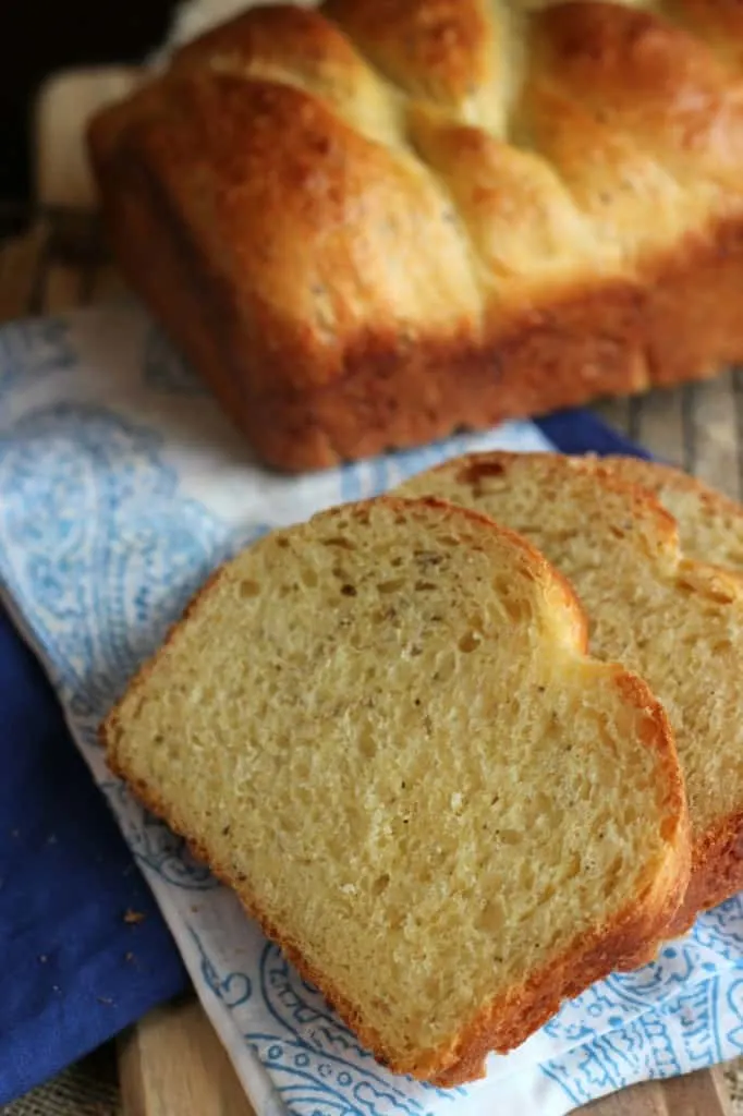 Italian Easter Cheese Bread with two slices in front and loaf of bread in background