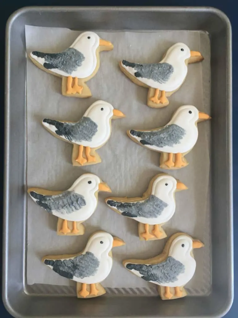 seagull cookies on parchment paper and cooking sheet