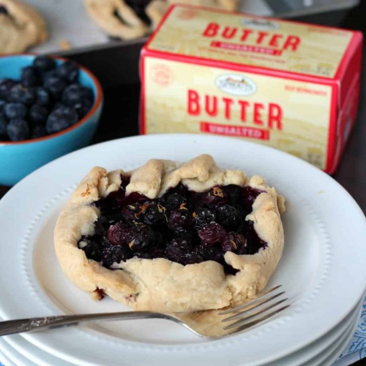 Blueberry galette on a white plate with Sprouts farmers market butter