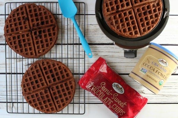 Chocolate waffles in a waffle iron with chocolate chips
