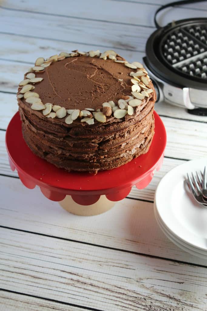 Frosted Chocolate Almond Cake made with layers of chocolate waffles