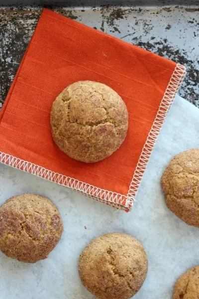 Pumpkin Snickerdoodle cookie on orange napkin and metal baking pan