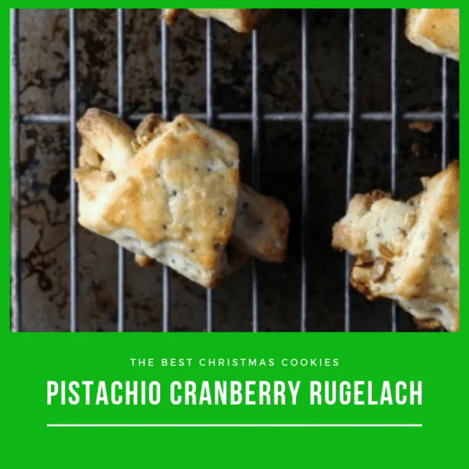 Pistachio Cranberry Ruglach cookies on a wire cooling rack on top of a baking sheet