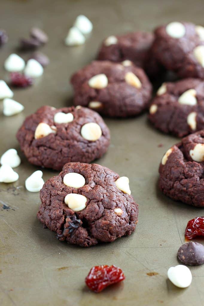 double chocolate chip cookies with dried cherries on a baking pan