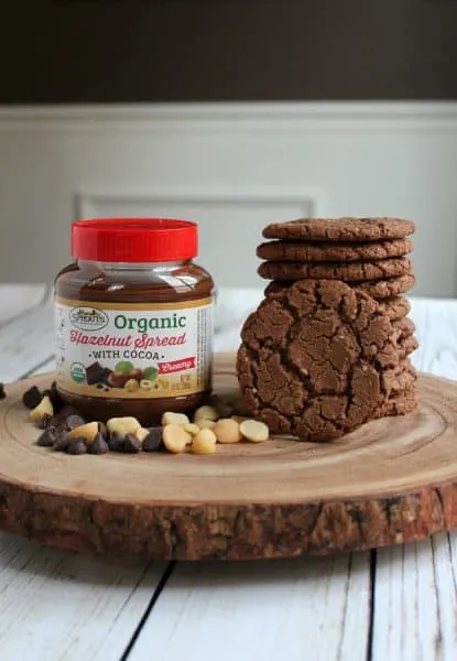 jar of hazelnut spread next to stack of chocolate cookies