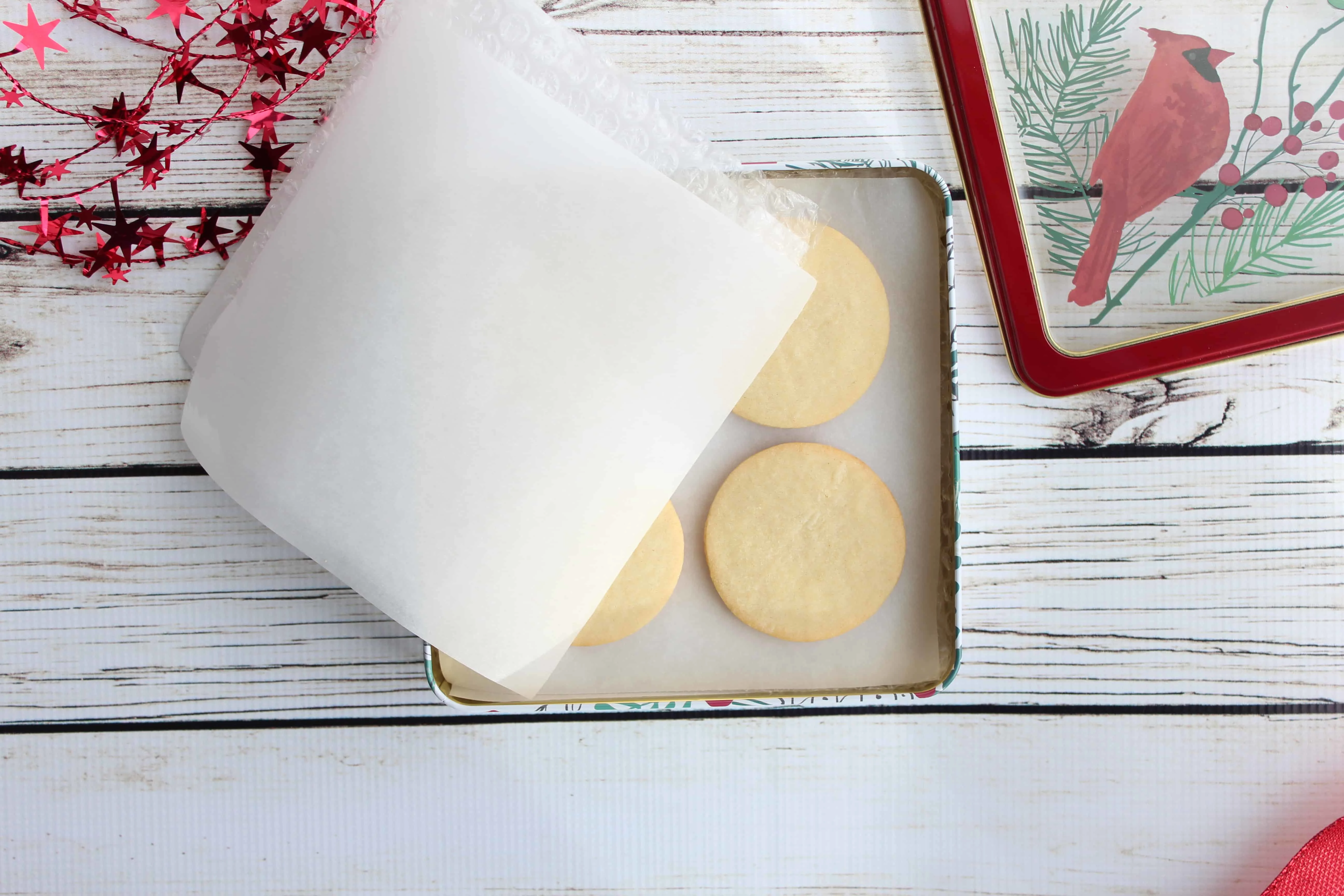 Circular cookies in a square tin with parchment paper