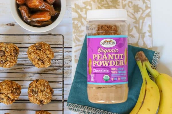 jar of peanut powder next to breakfast cookies on wire rack