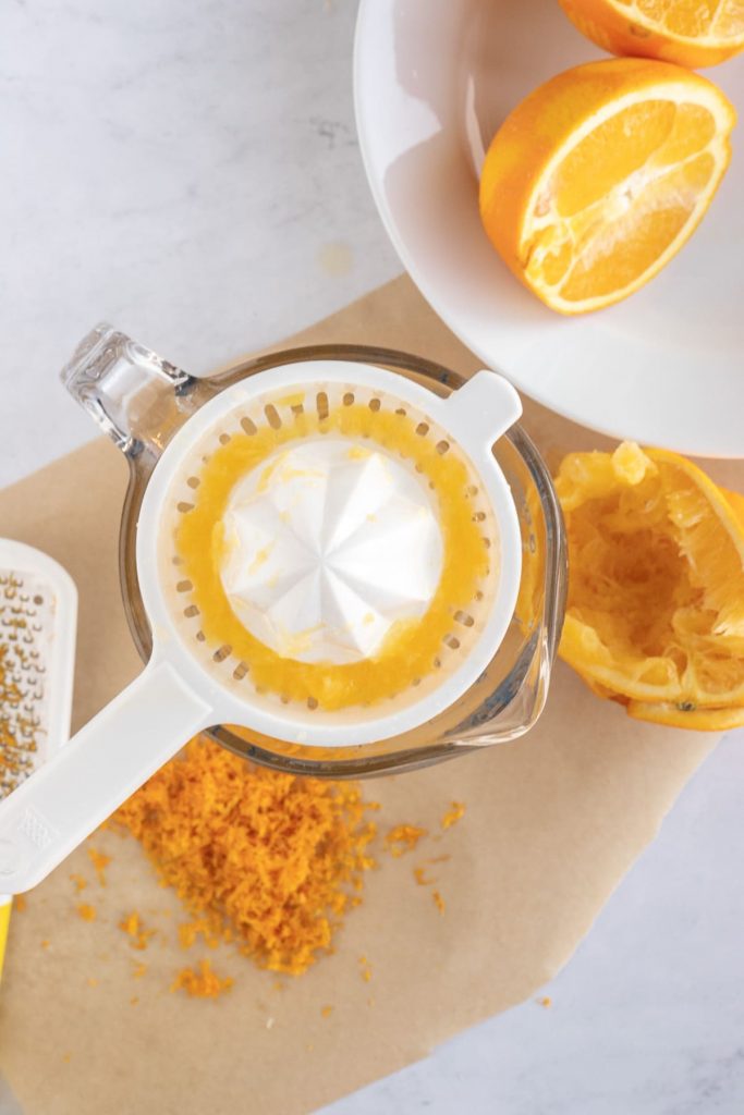 orange zest and orange juice with juice squeezer