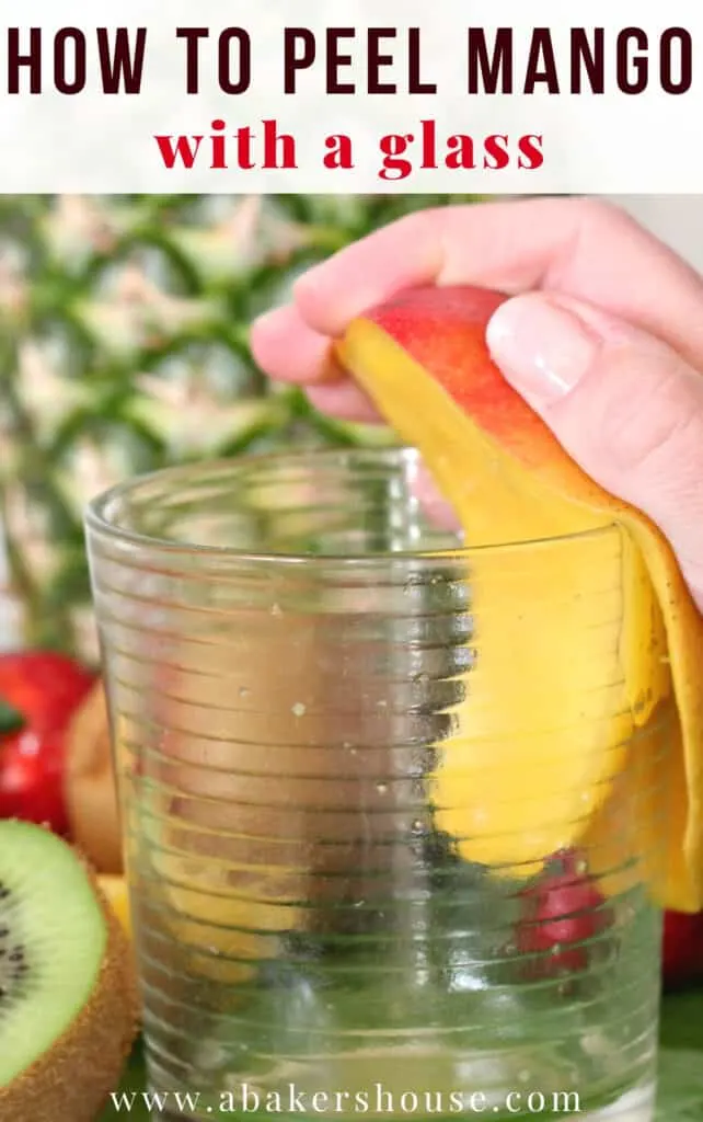 Hand peeling mango using a glass