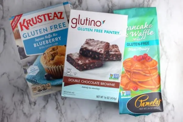 three Gluten Free Baking Mixes on a marble countertop