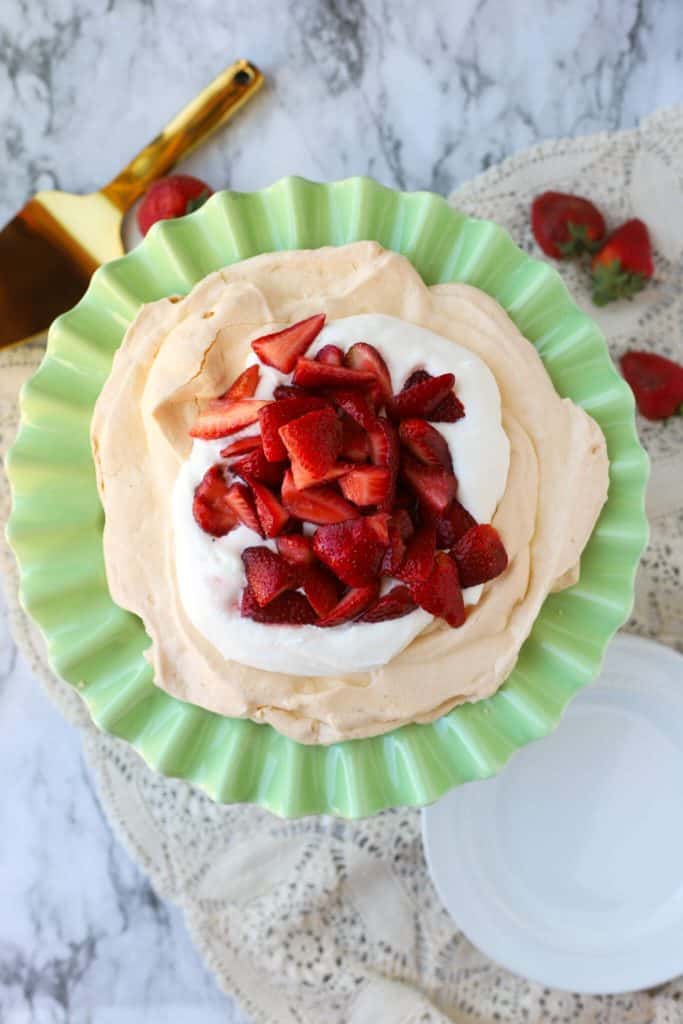 Macerated Berries as a topping on pavlova on green cake platter