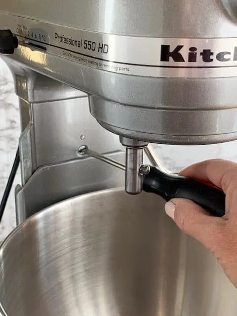A screwdriver is used to make adjustments to blade level height on KitchenAid lift bowl mixer
