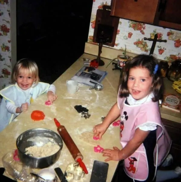 Young holly baker baking cookies with her sister