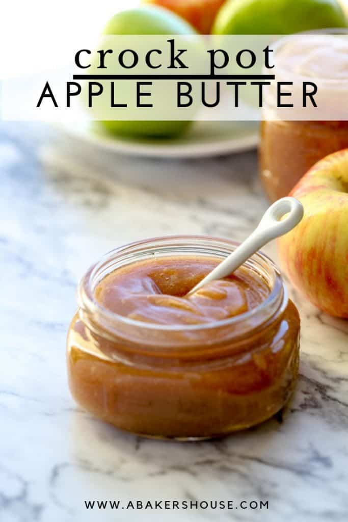 Mason jar filled with apple butter on a marble counter