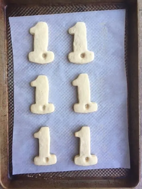 six baked cookies on a parchment lined baking sheet