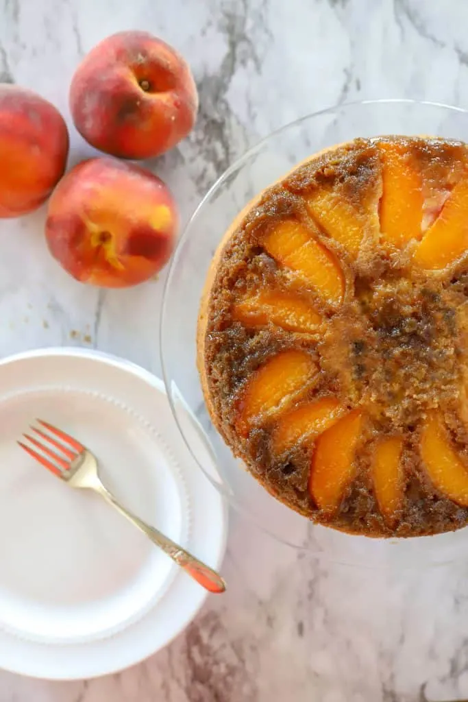 Gluten free upside down peach cake baked with white plate and fork