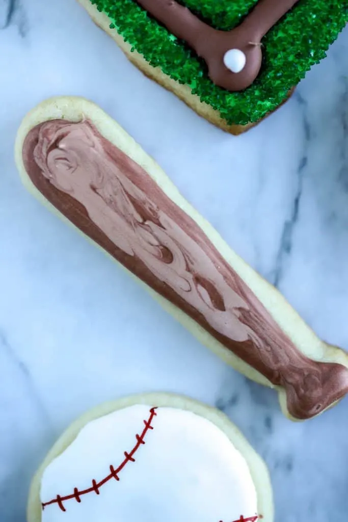 Baseball bat cookie is a sugar cookie decorated with two colors of brown royal icing