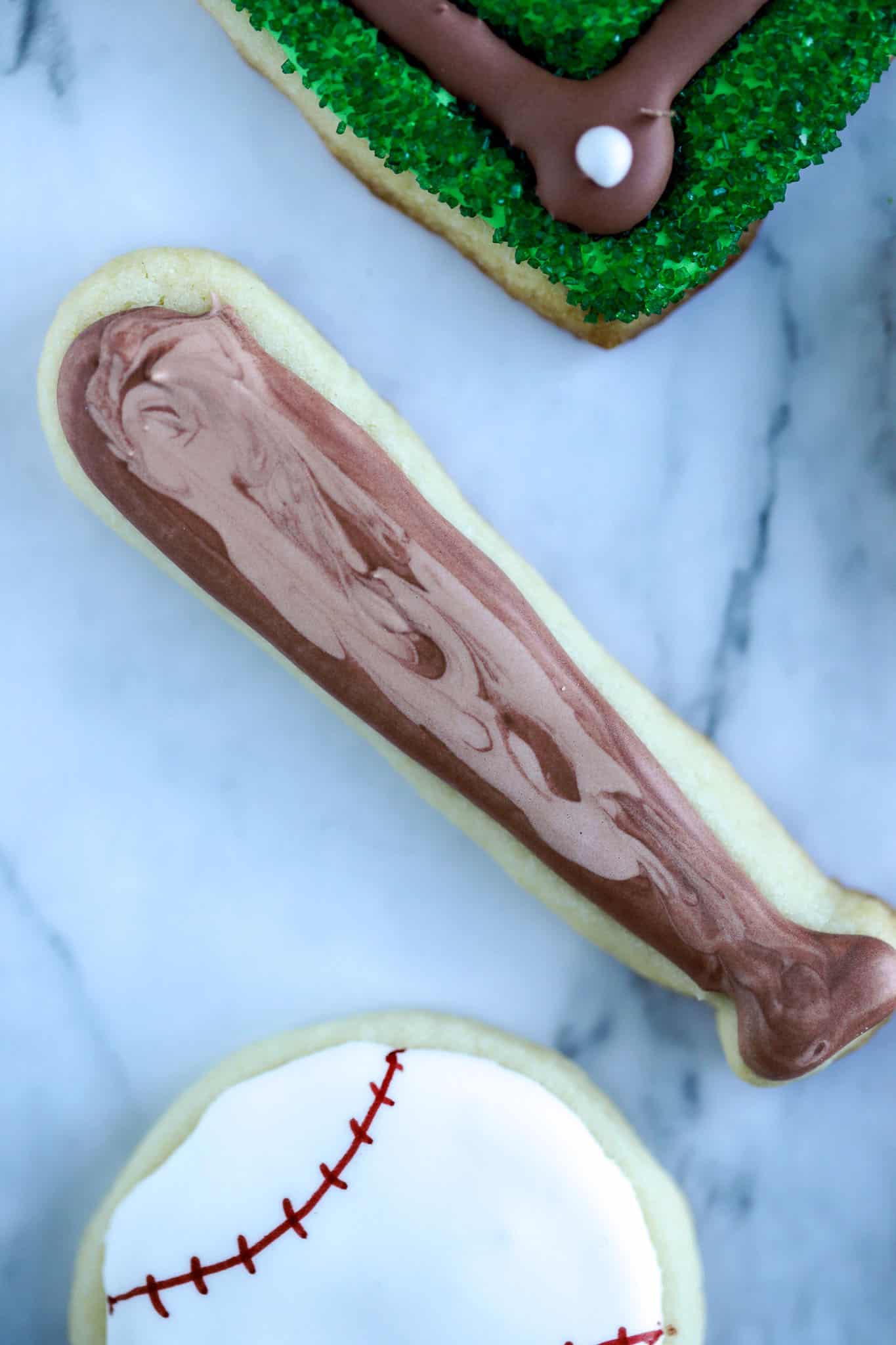 Baseball bat cookie is a sugar cookie decorated with two colors of brown royal icing