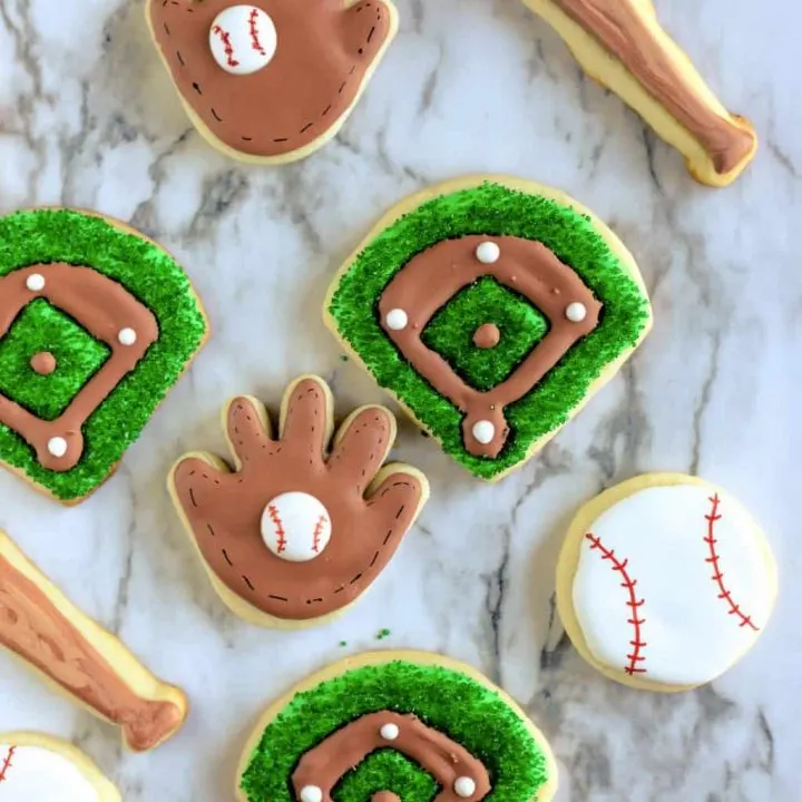 Assortment of baseball cookies including gloves, balls, bats and baseball diamonds
