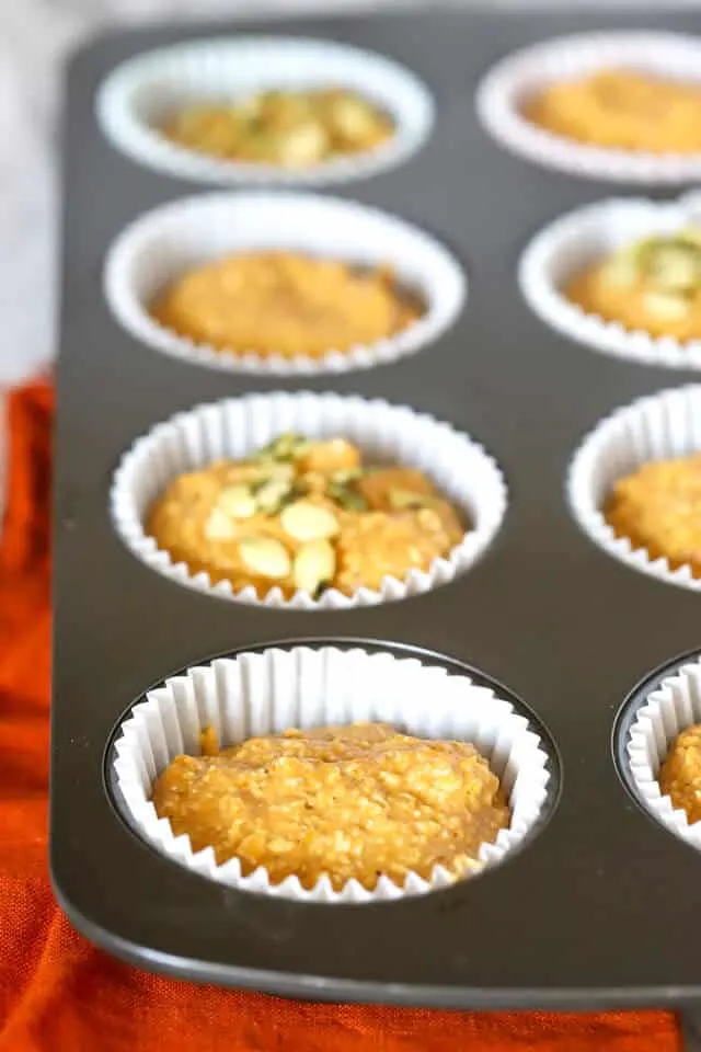 Filled muffin tin with batter for healthy pumpkin muffins for kids before baking