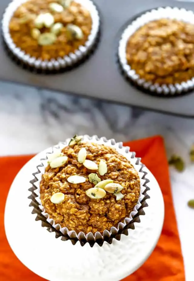 Overhead photo of healthy pumpkin muffins topped with pumpkin seeds