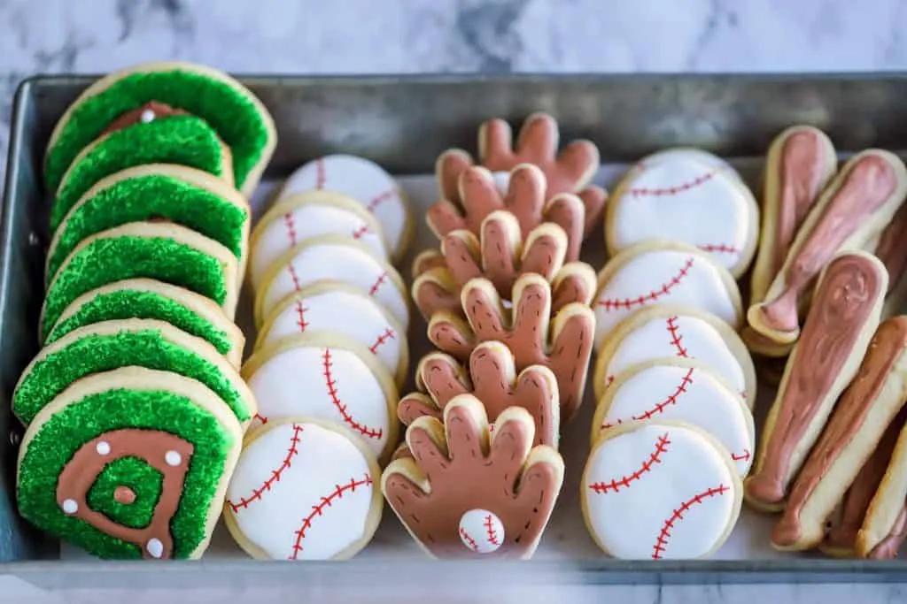 platter of baseball cookies including baseball diamonds, baseballs, gloves and bats