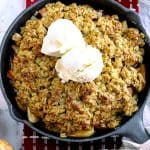 Gluten free baked easy apple crisp with two scoops of vanilla ice cream on top