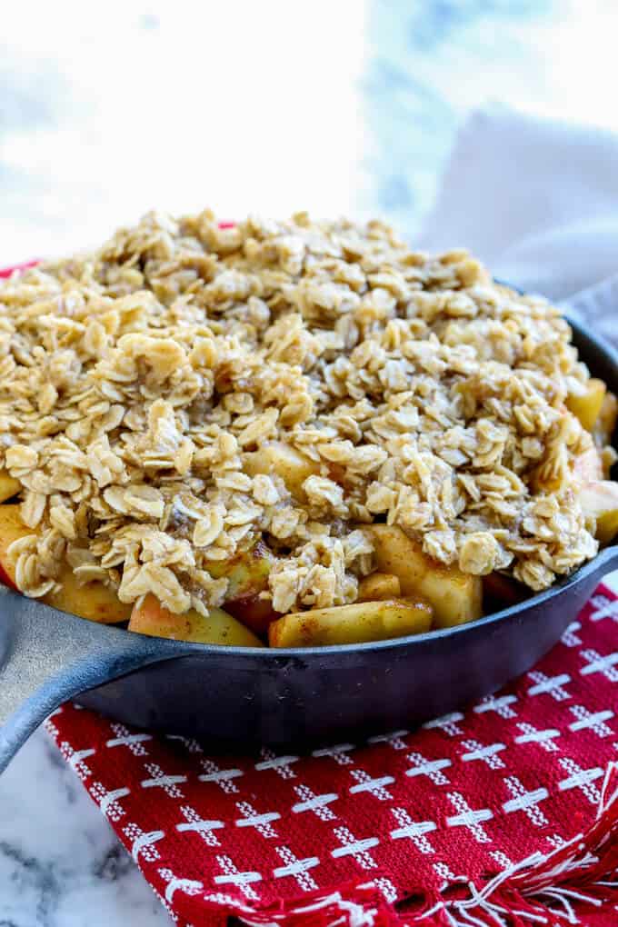 Gluten free easy apple crisp ingredients in a cast iron skillet before baking