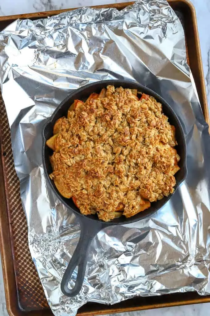 Baked easy apple crisp on baking tray covered with aluminum foil