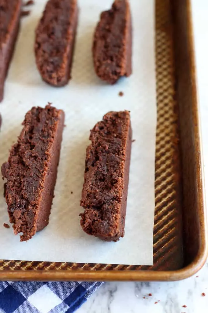 sliced chocolate biscotti on a baking pan