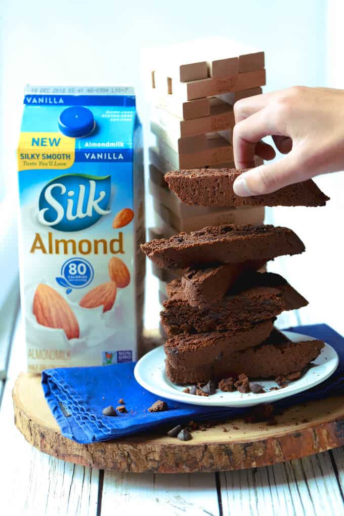 Stack of vegan chocolate biscotti with carton of Silk almondmilk