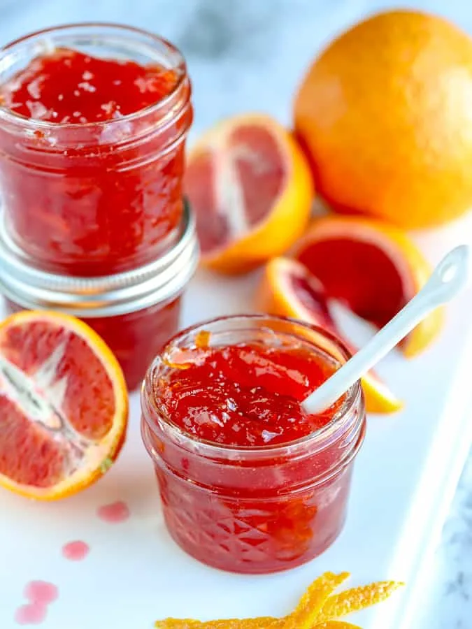 Mason jars filled with blood orange marmalade