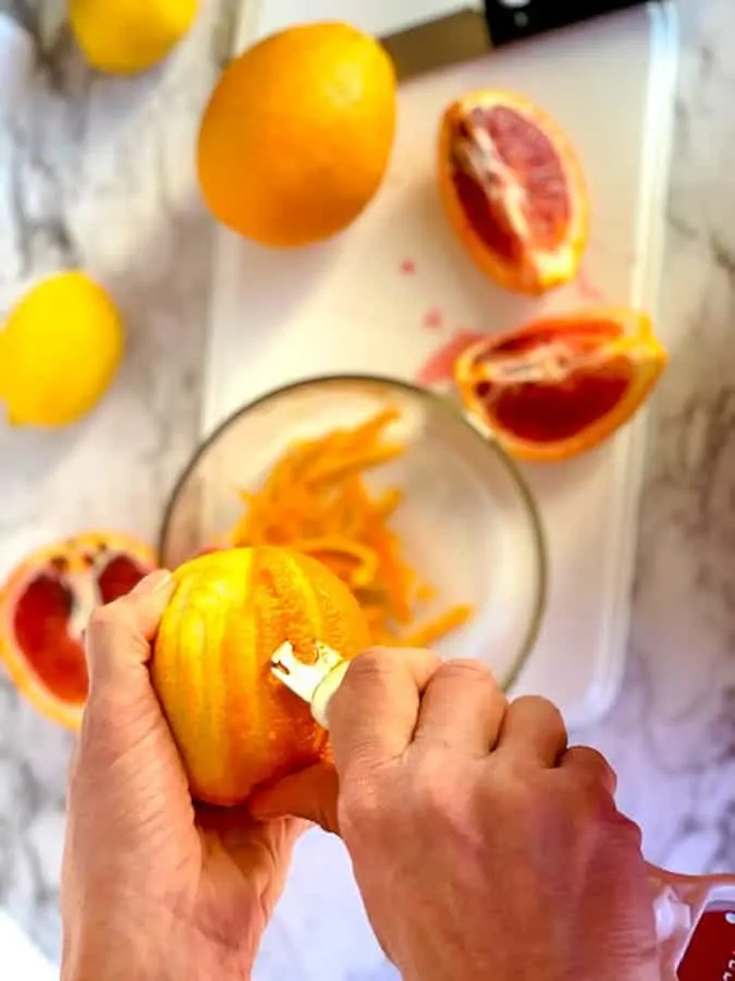 Use a citrus zester to take the zest off of the blood orange in making marmalade