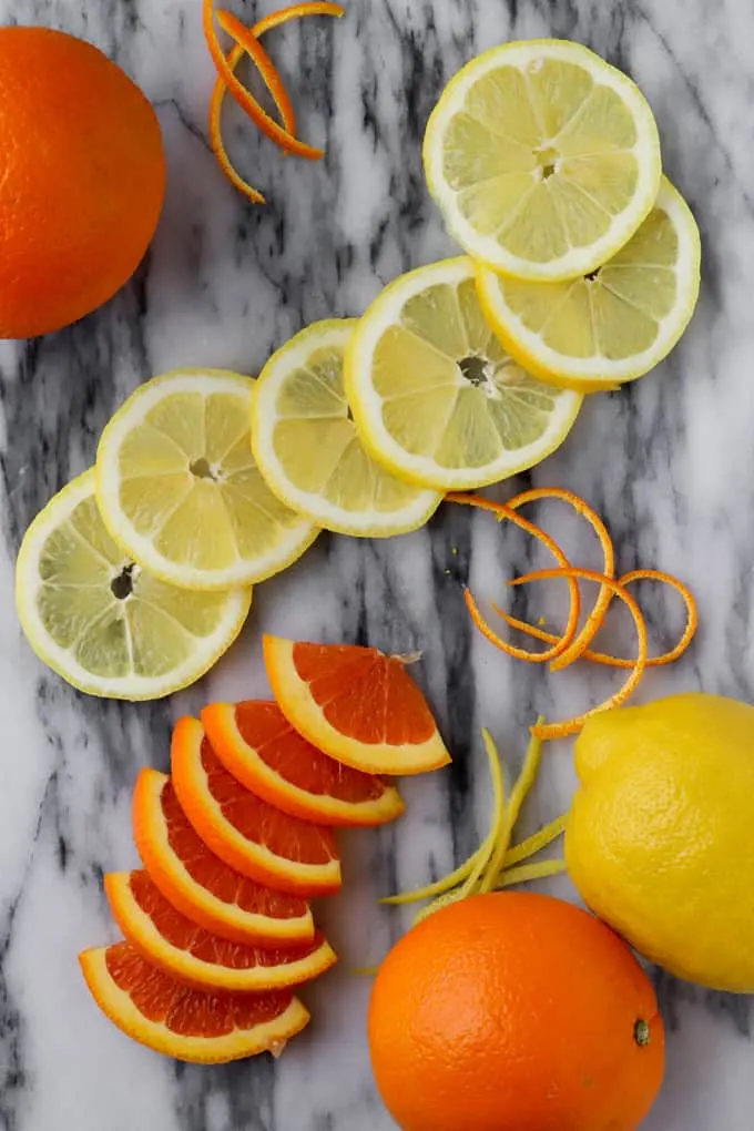 slices of lemons and cara cara oranges on a marble board