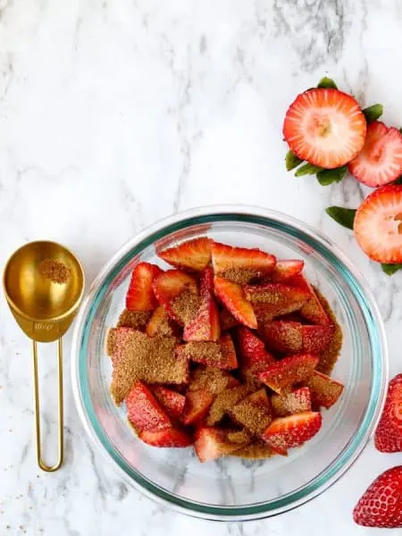 Strawberries in glass bowl with coconut sugar to macerate strawberries