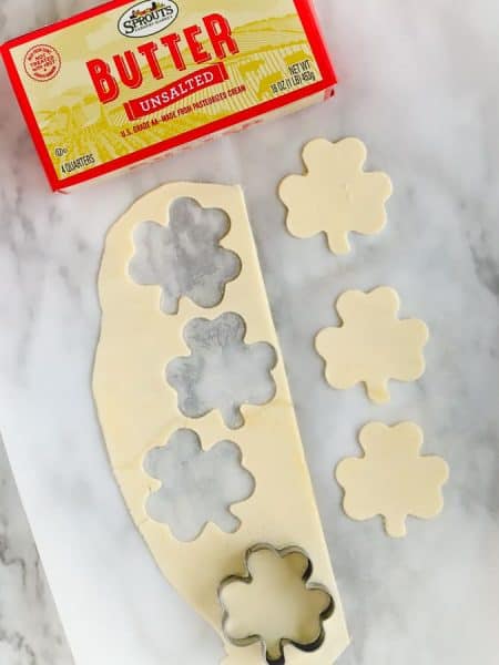 Shamrock shapes of butter cut with cookie cutters for st patricks day