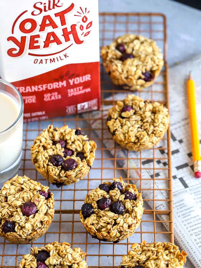 Baked Oatmeal Cups with Blueberries and oatmilk with morning newspaper