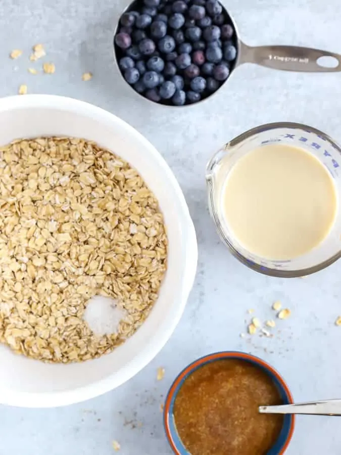 Ingredients of oats, blueberries and oatmilk for bluerberry oatmeal cups