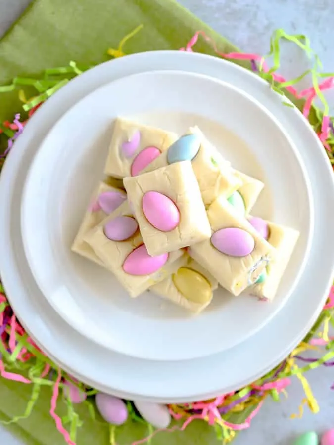 white chocolate fudge with Easter candy stacked on a white plate