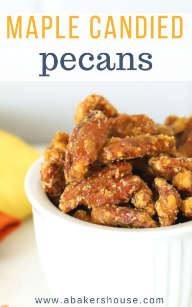 Close up photo of candied pecans with maple syrup in a white bowl for Pinterest sharing