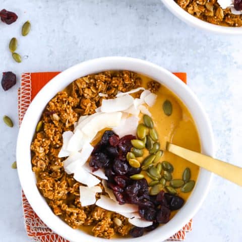 Pumpkin smoothie bowl with Oat Yeah oatmilk in white bowls with orange napkin